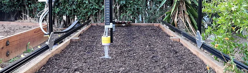 FarmBot machine watering garden beds